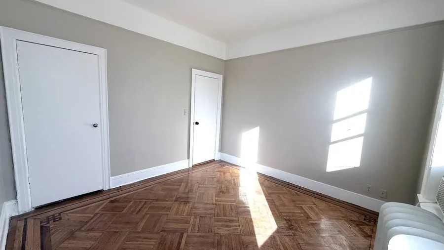 Bedroom repainted and floor refinished during a Brooklyn apartment turnover