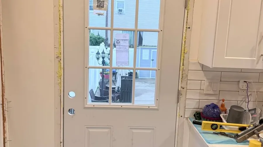 New entry door hung and foam-sealed around the frame in Staten Island
