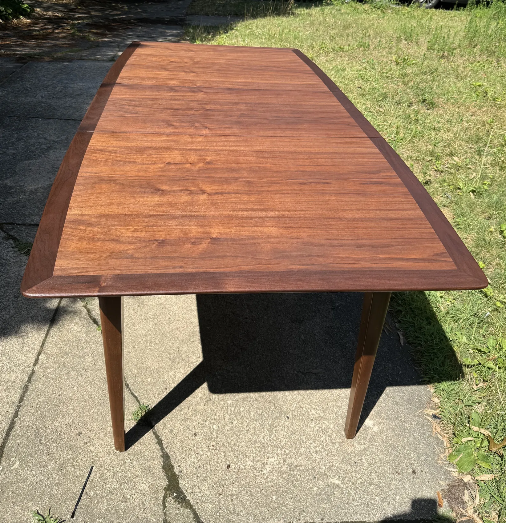 Wide view of refinished wood tabletop with new protective finish
