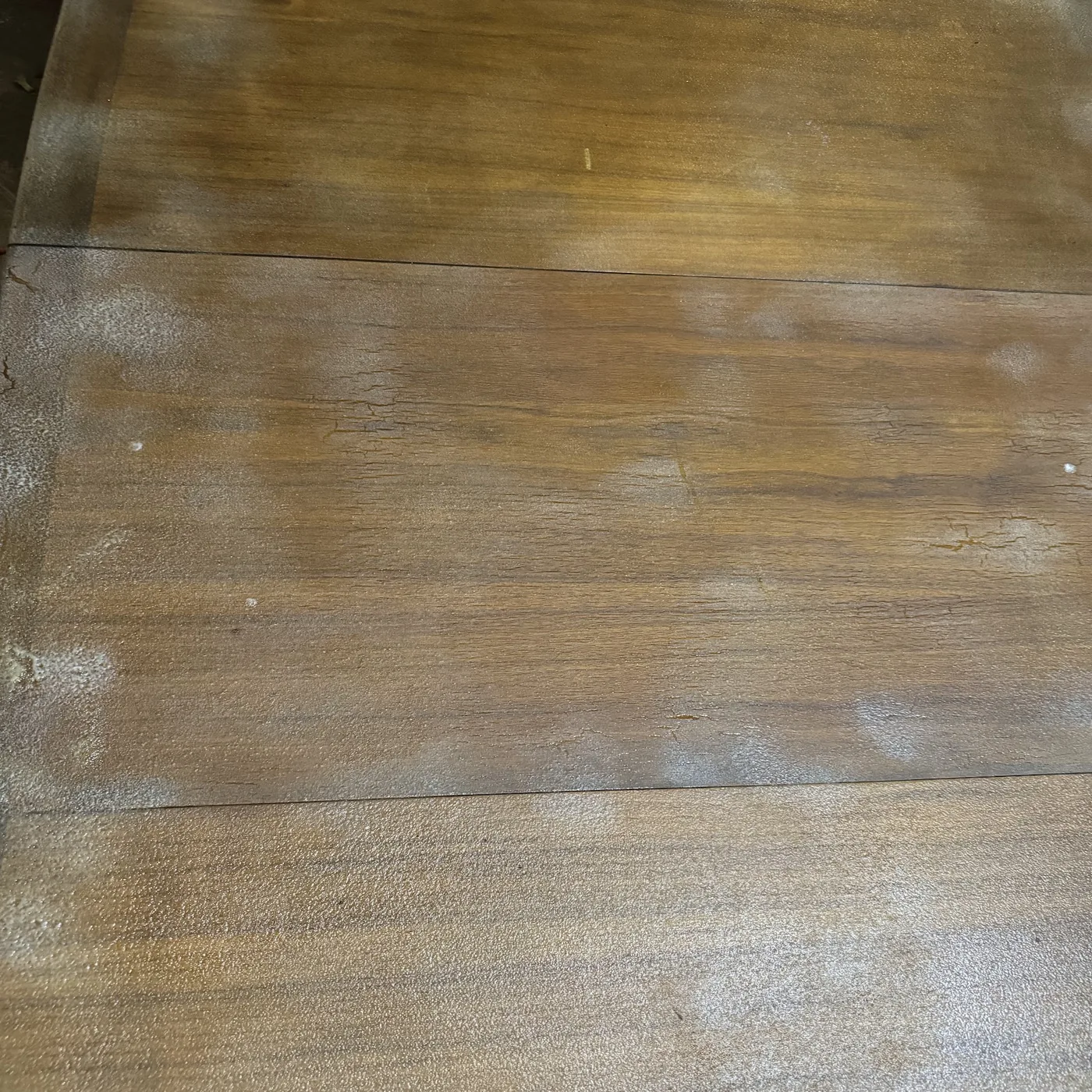 Close-up of cloudy failed polyurethane coating on a wood table