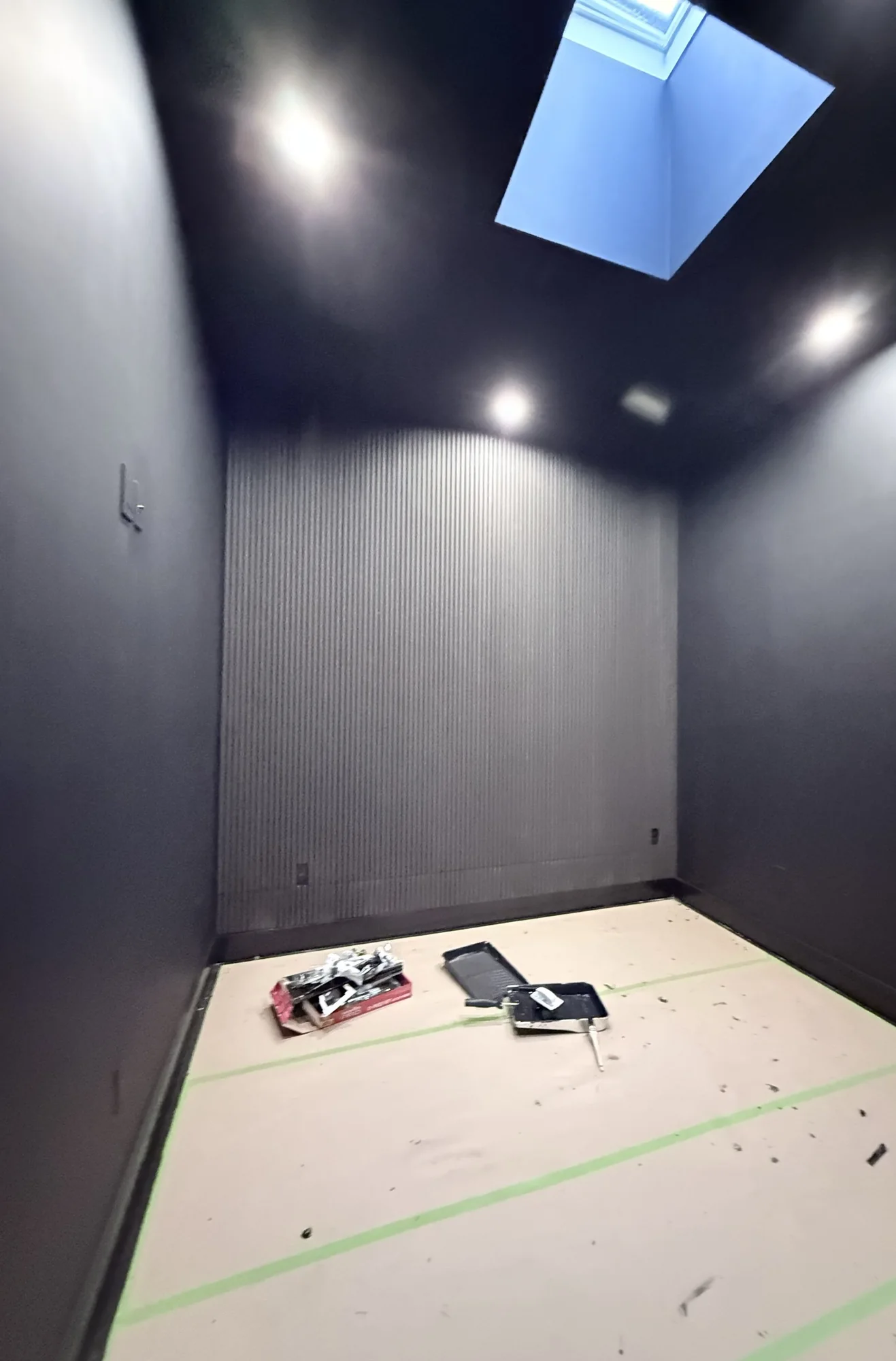 All-Black Lounge Room With a Wood Slat Accent Wall in Bed-Stuy, Brooklyn