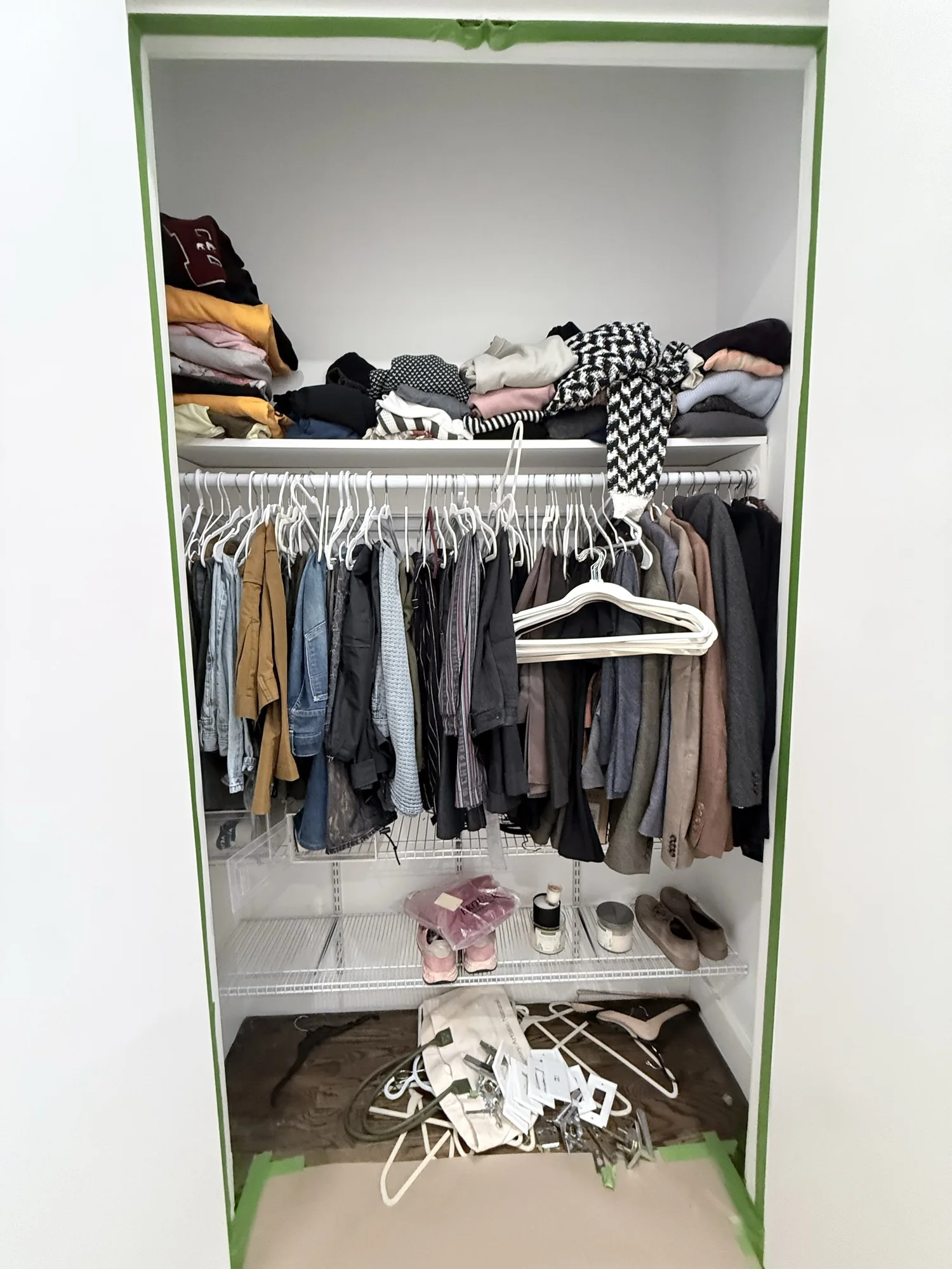 Closet full of clothes sealed off with tape and paper to protect it during painting