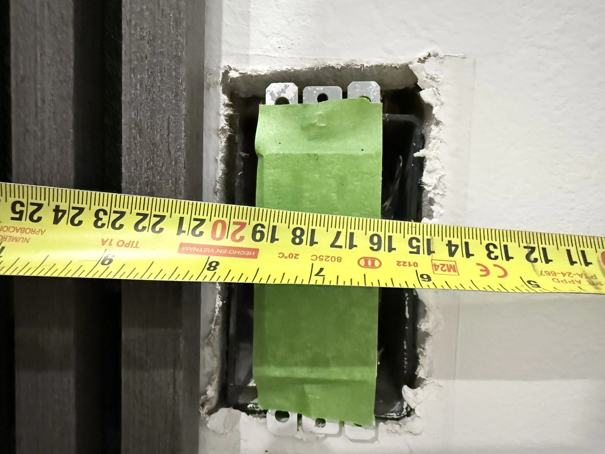Measuring an outlet opening to lay out the wood slat accent wall panels