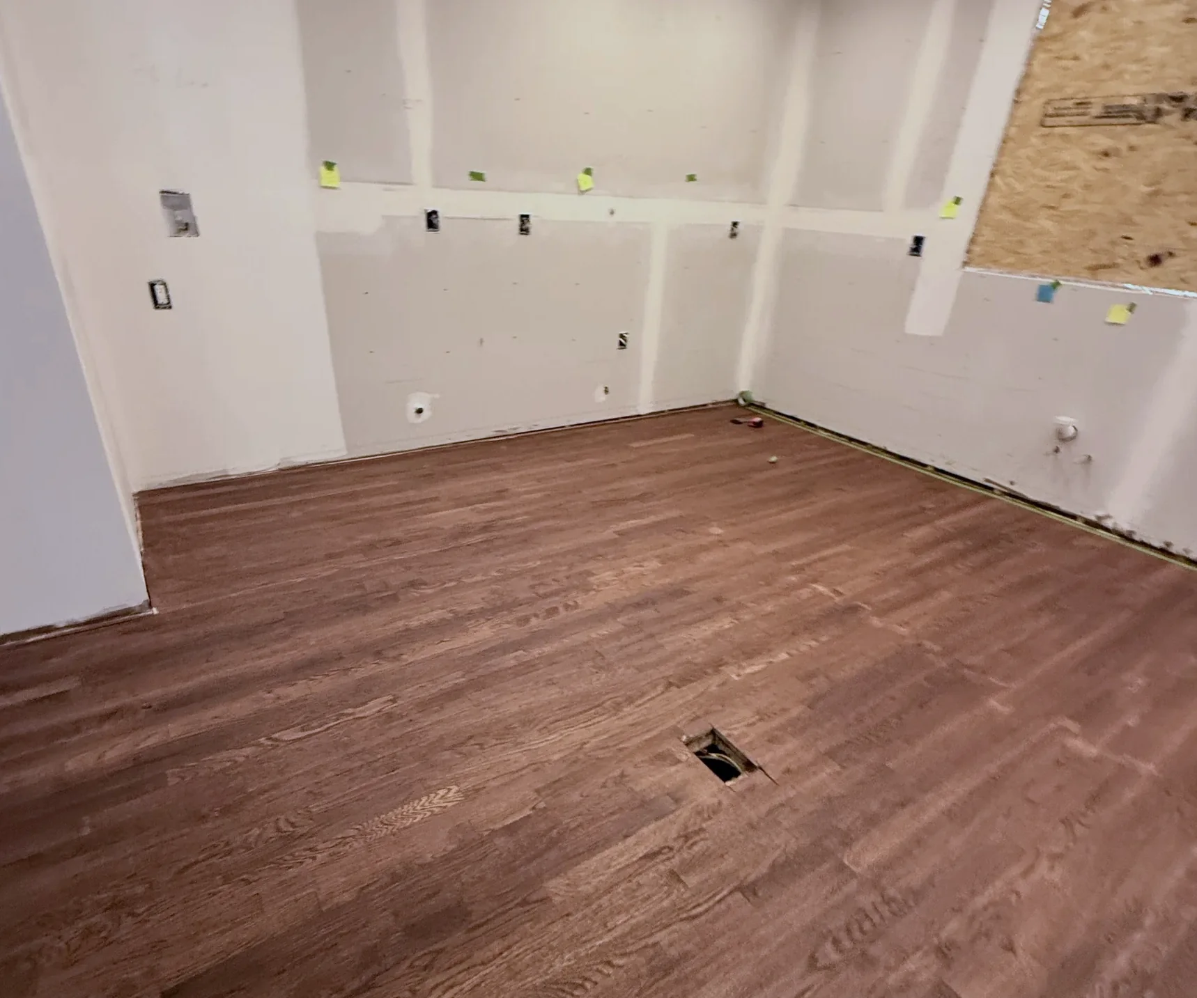 Bare stained wood floor before the chess pattern, from the same viewpoint — Baldwin NY