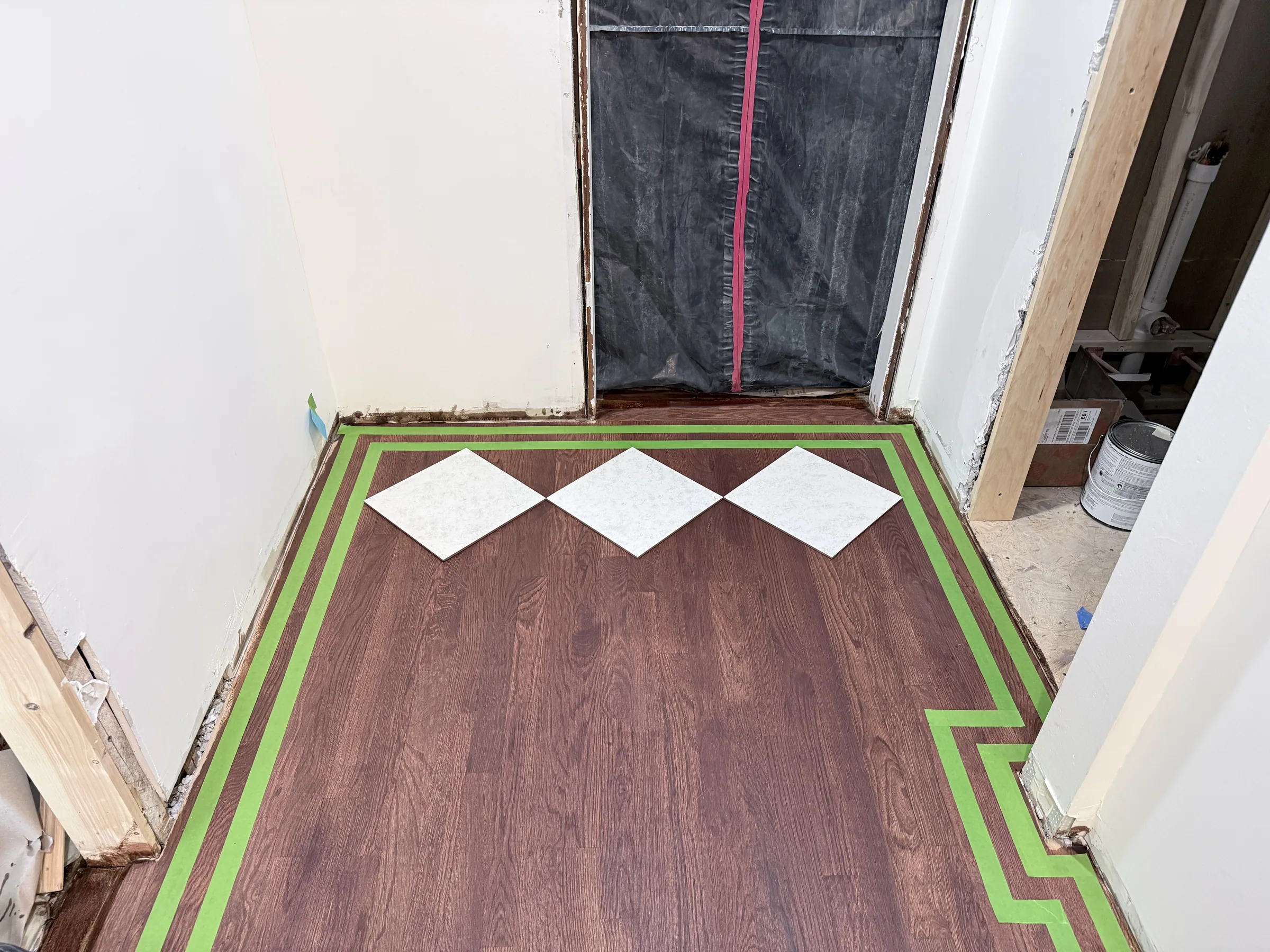 Diamond template tiles placed on the floor to set the chess pattern scale