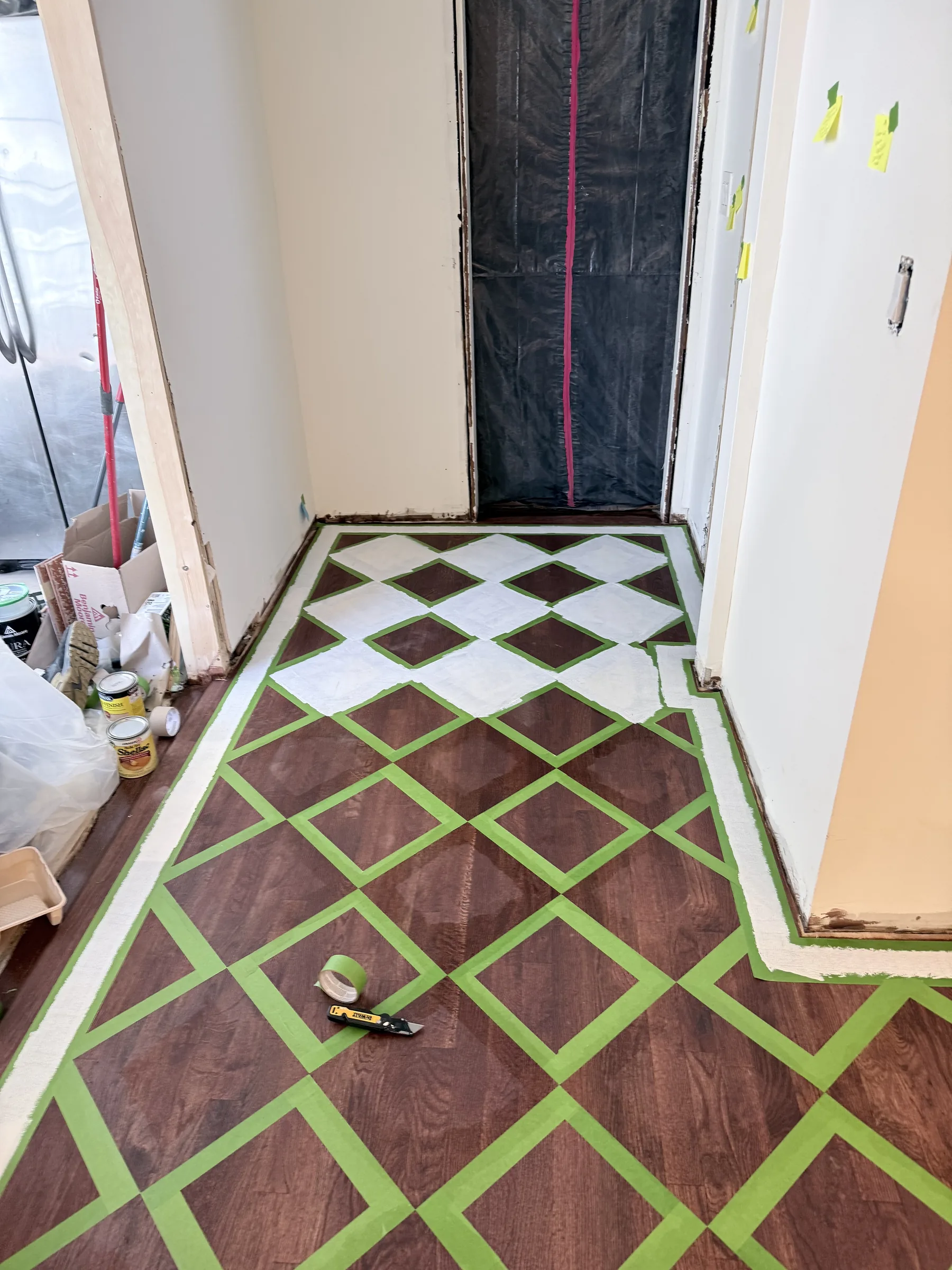 Painting the first coat onto alternating diamonds in a corner of the room