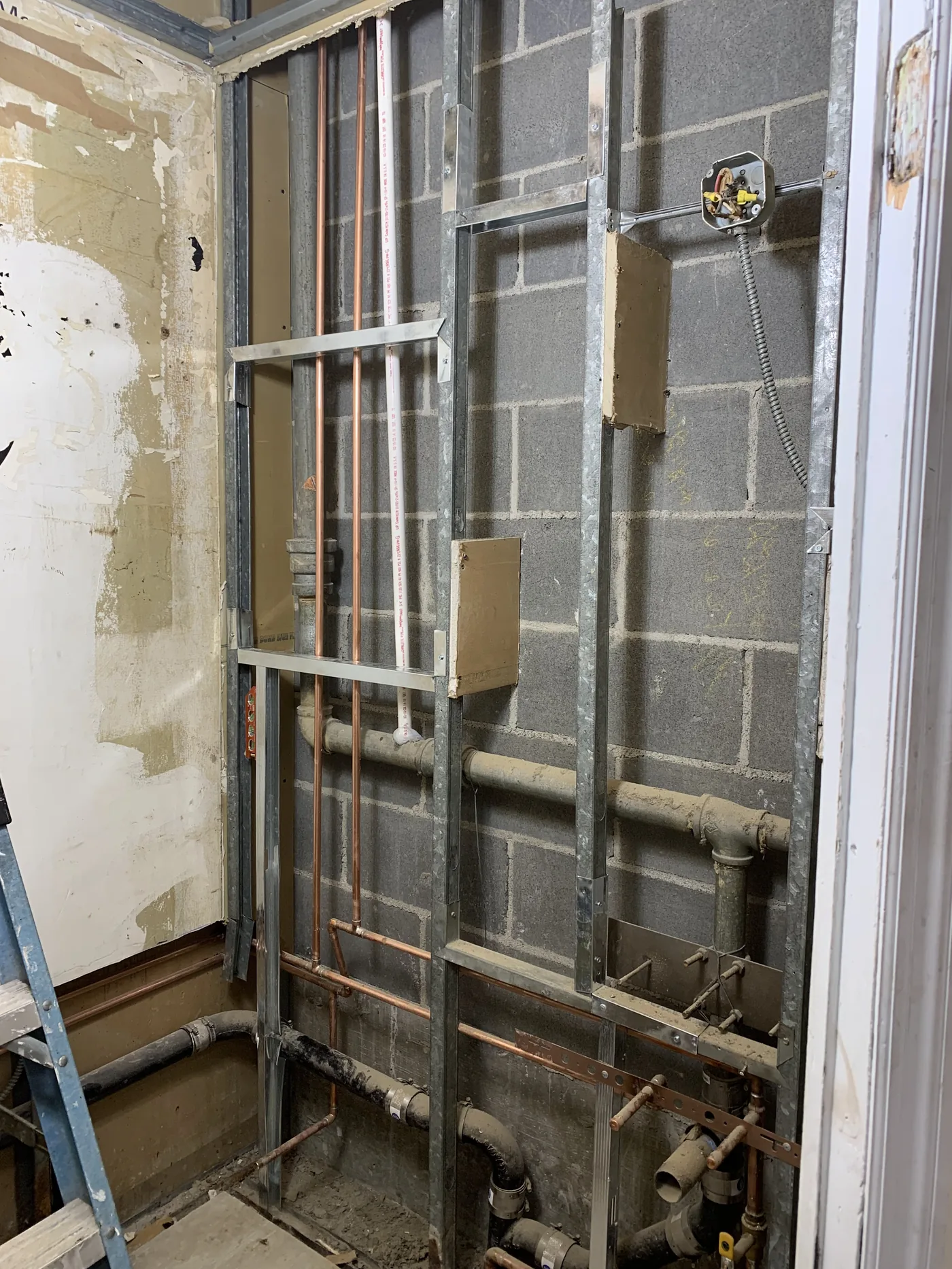 Main customer area before repairs, with uneven and damaged wall surfaces