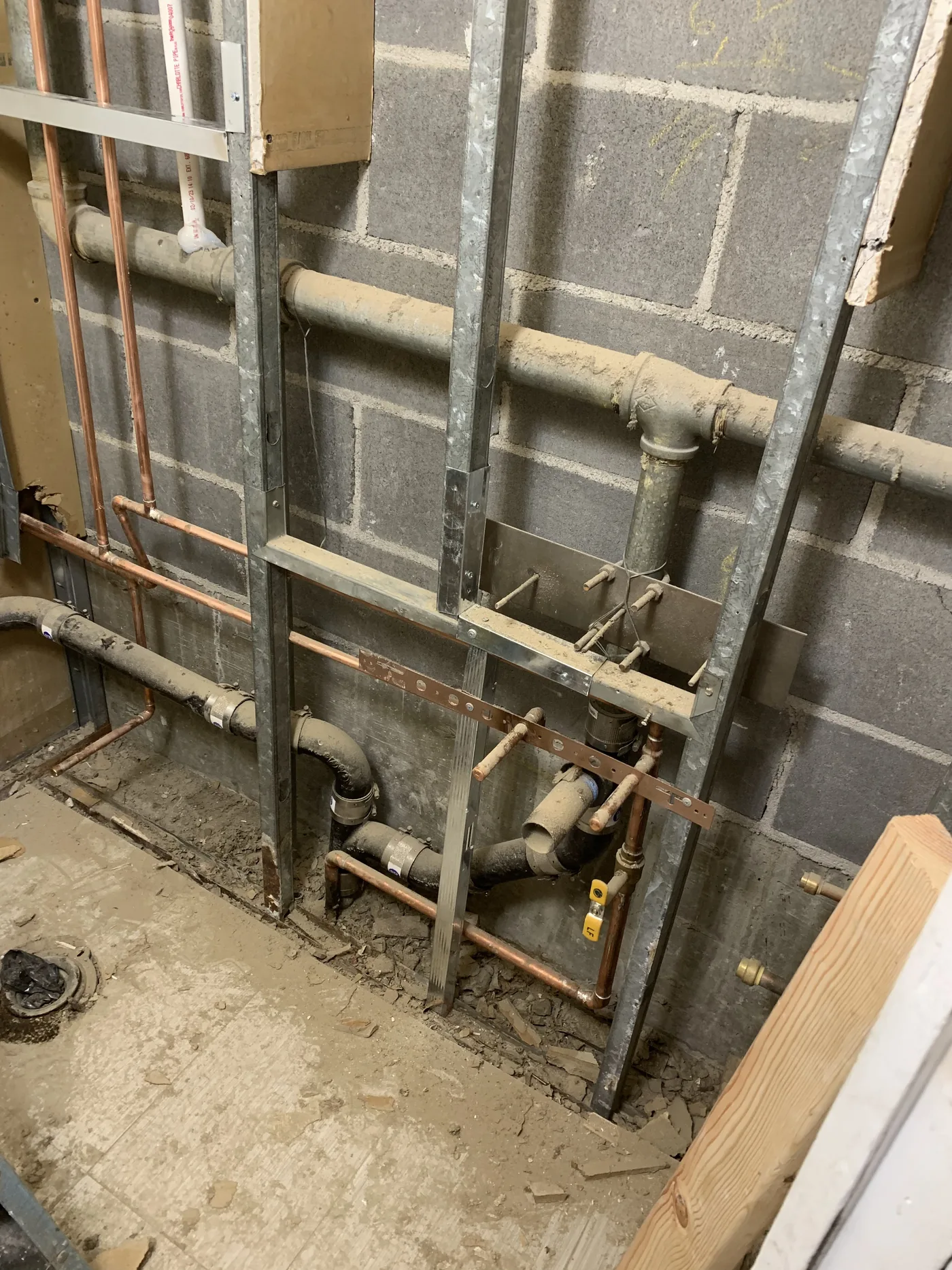 The restroom area started with open walls, rough plumbing, and no finished ceiling