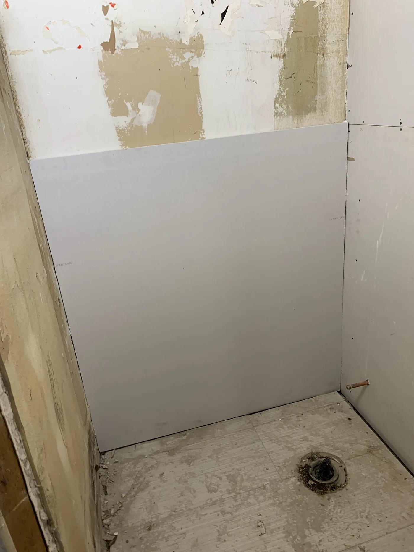 New drywall installation began in the restroom to close rough wall sections
