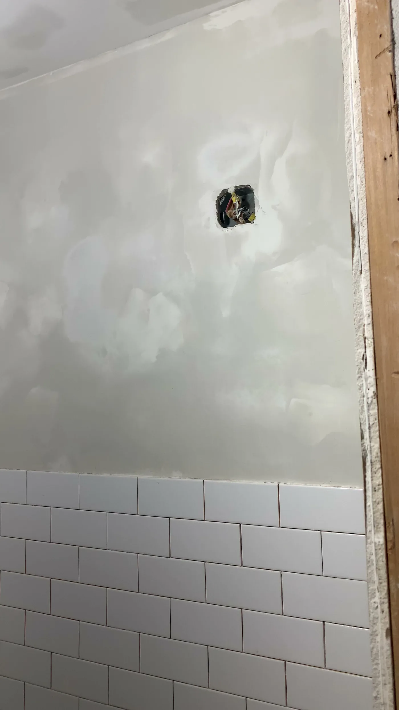 Repairing and leveling old drywall in the main customer space