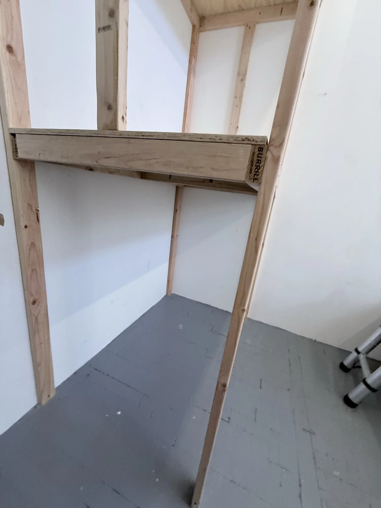 Close view of the lower shelf frame and posts of the custom storage rack