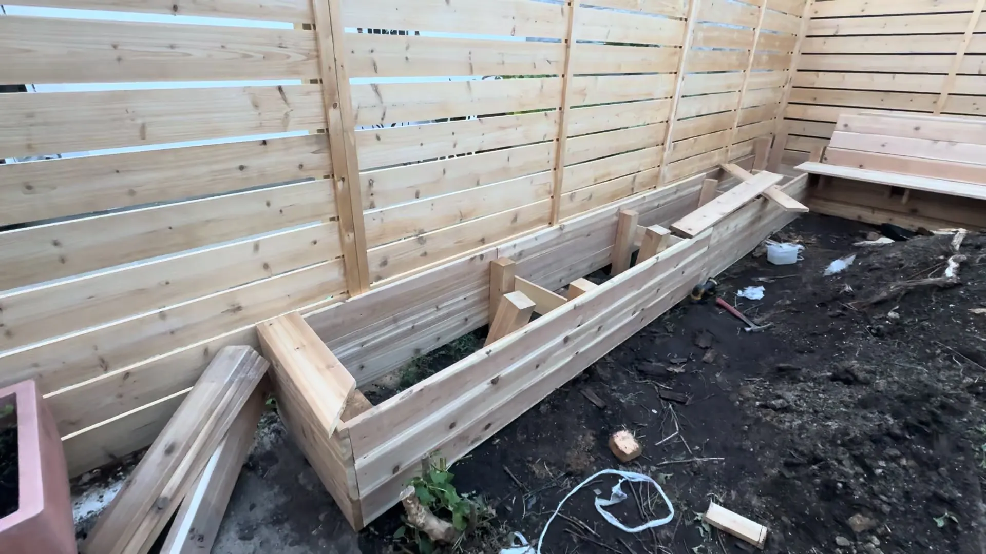 Prepared boards and supports during planter bench construction