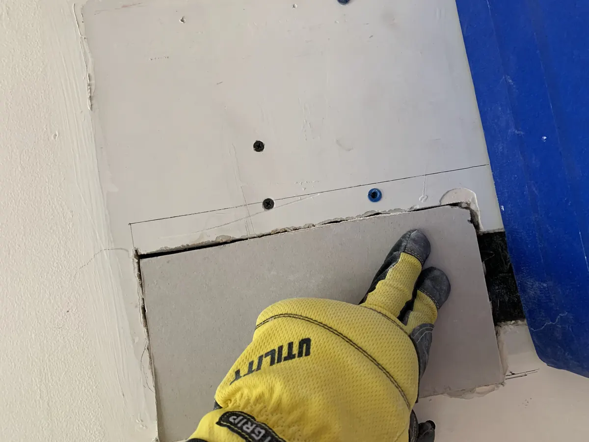 Fastening drywall patch around AC lines during wall repair