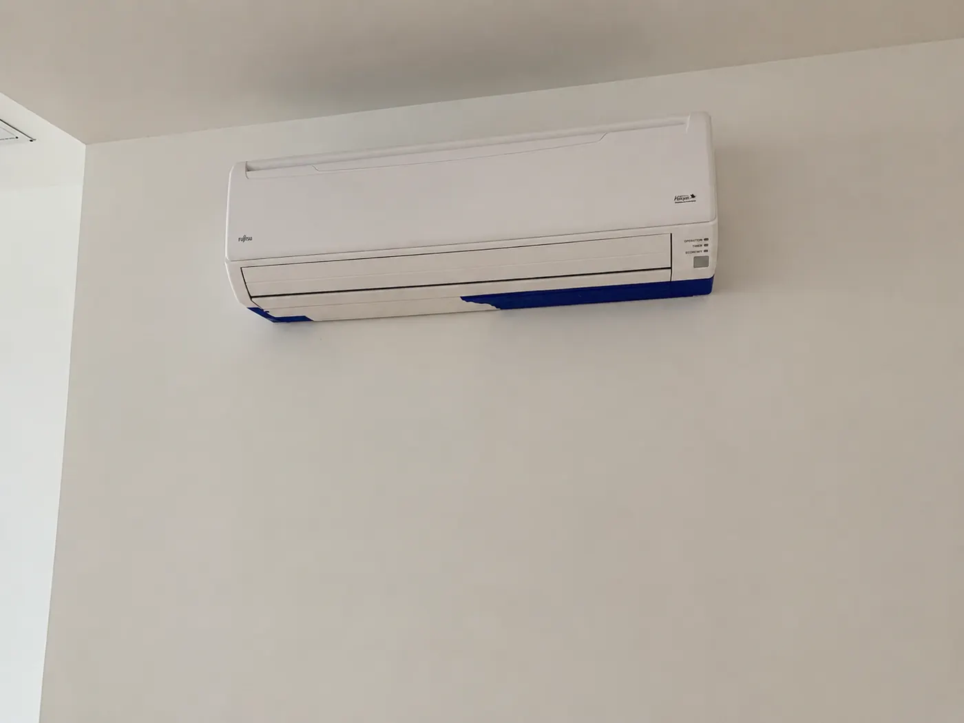 Finished clean wall around indoor mini-split AC unit after drywall repair