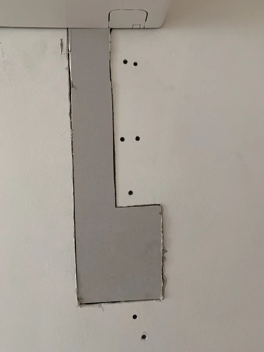 New drywall patch piece installed below the indoor AC unit
