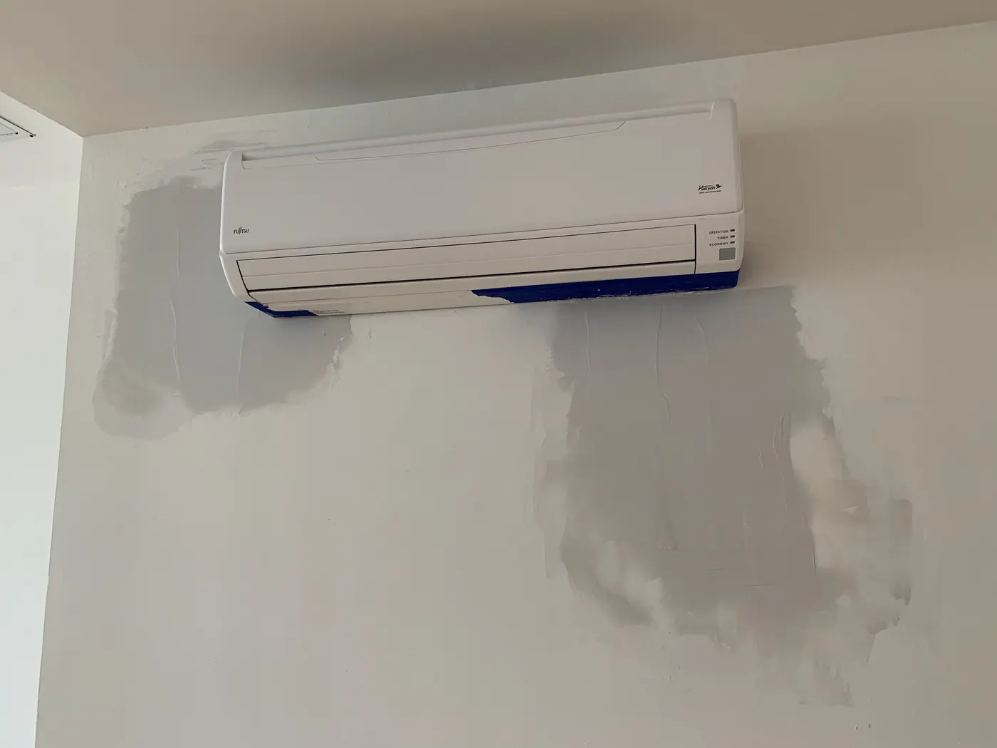Painted wall after drywall repair around mini-split AC unit