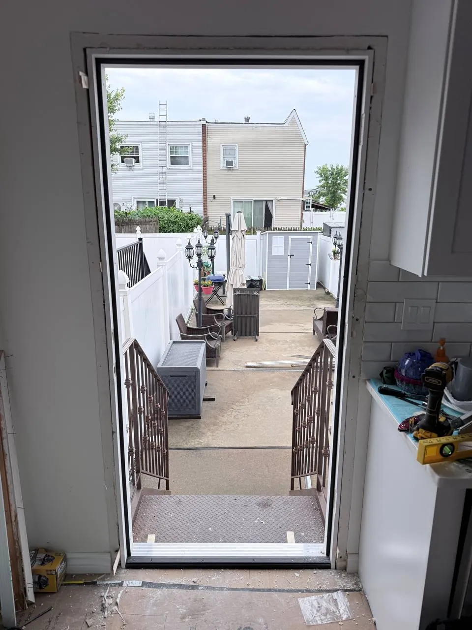 New prehung door frame set into the opening and shimmed level, seen from inside