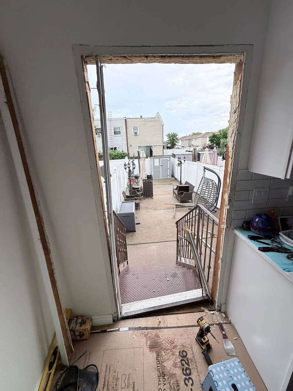 Rough door opening with old frame removed showing exposed framing and insulation