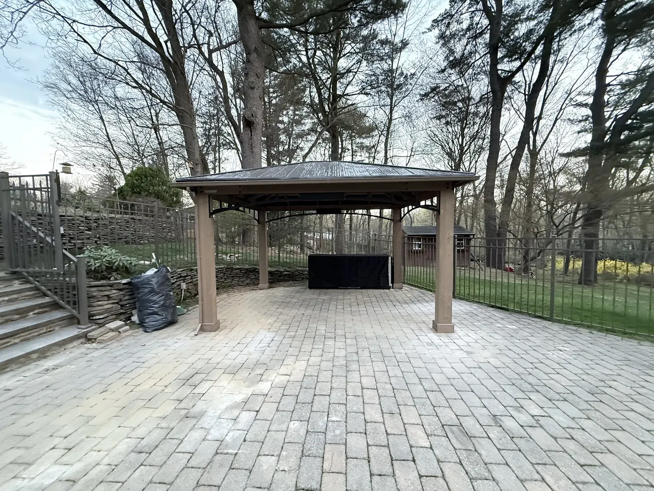 Finished hardtop gazebo with an outdoor kitchen on the paver patio