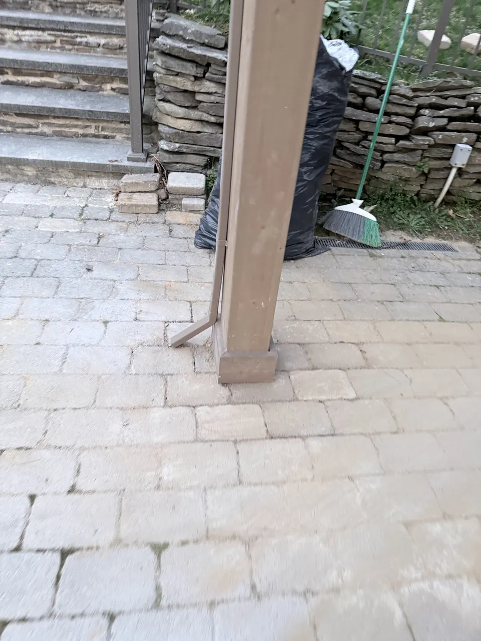 Base of a gazebo post set on its footing and flush with the surrounding pavers