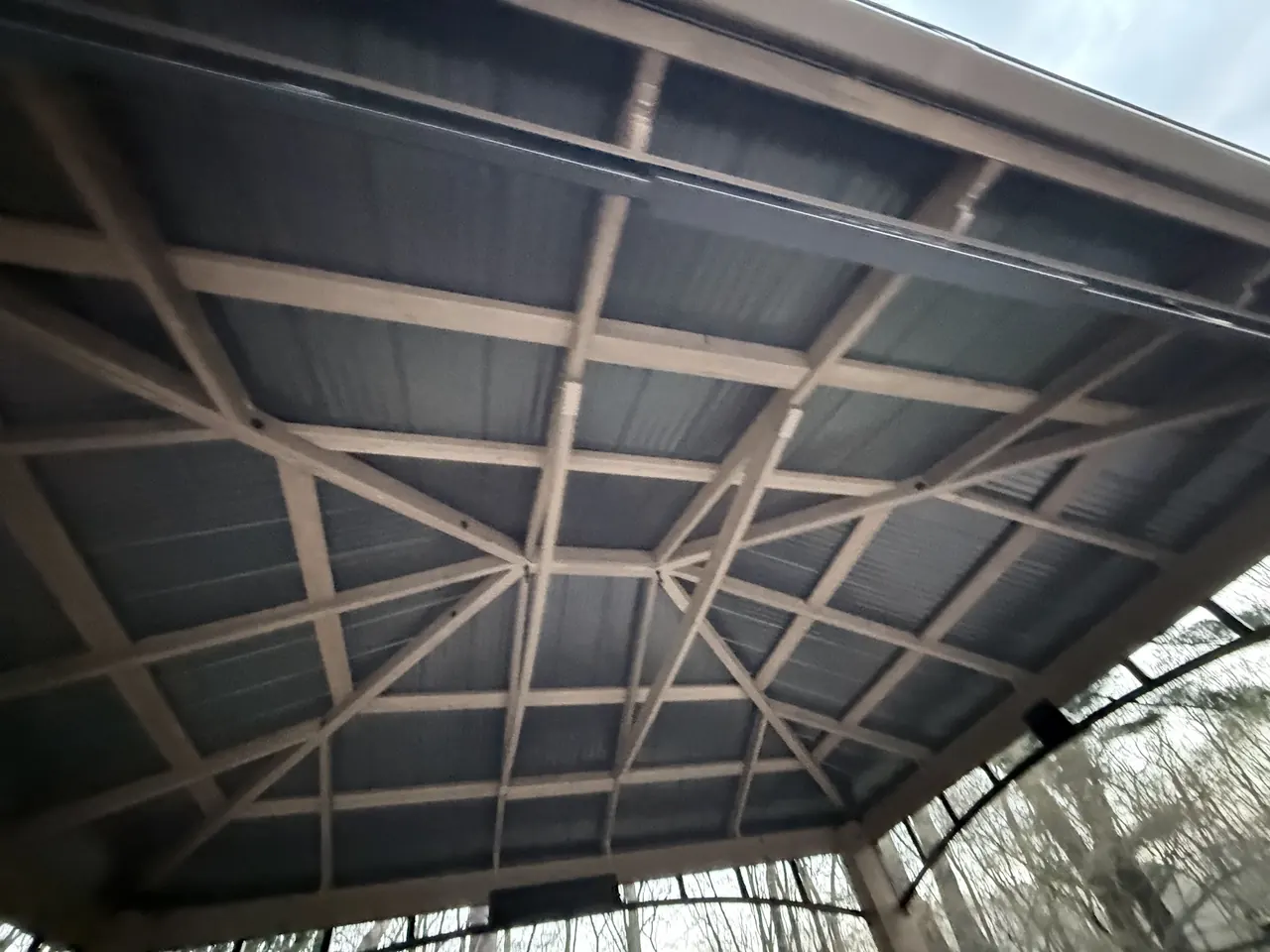 Underside of the assembled hardtop gazebo roof structure showing rafters