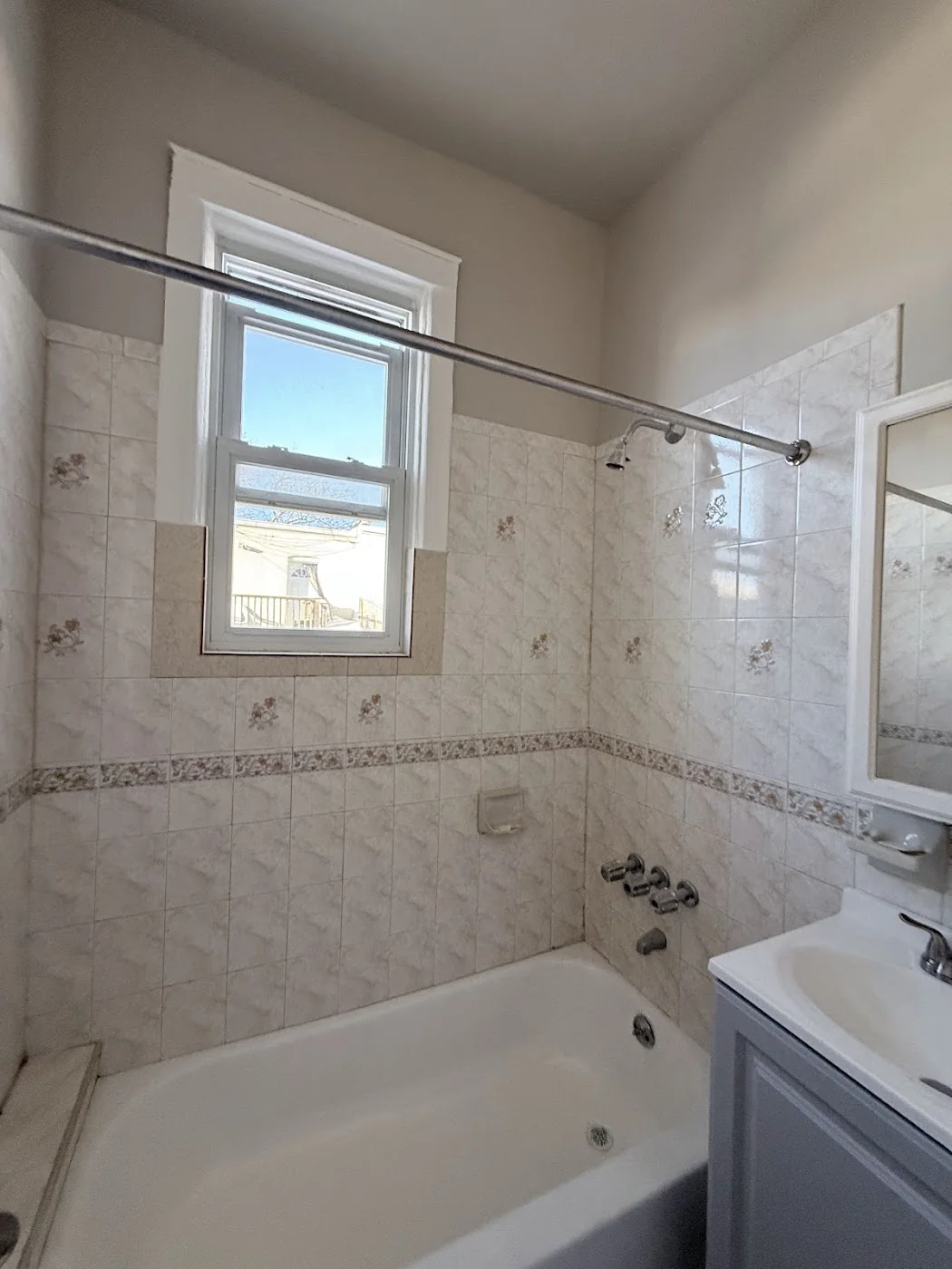 Bathroom after refresh with clean tub tile and fixtures