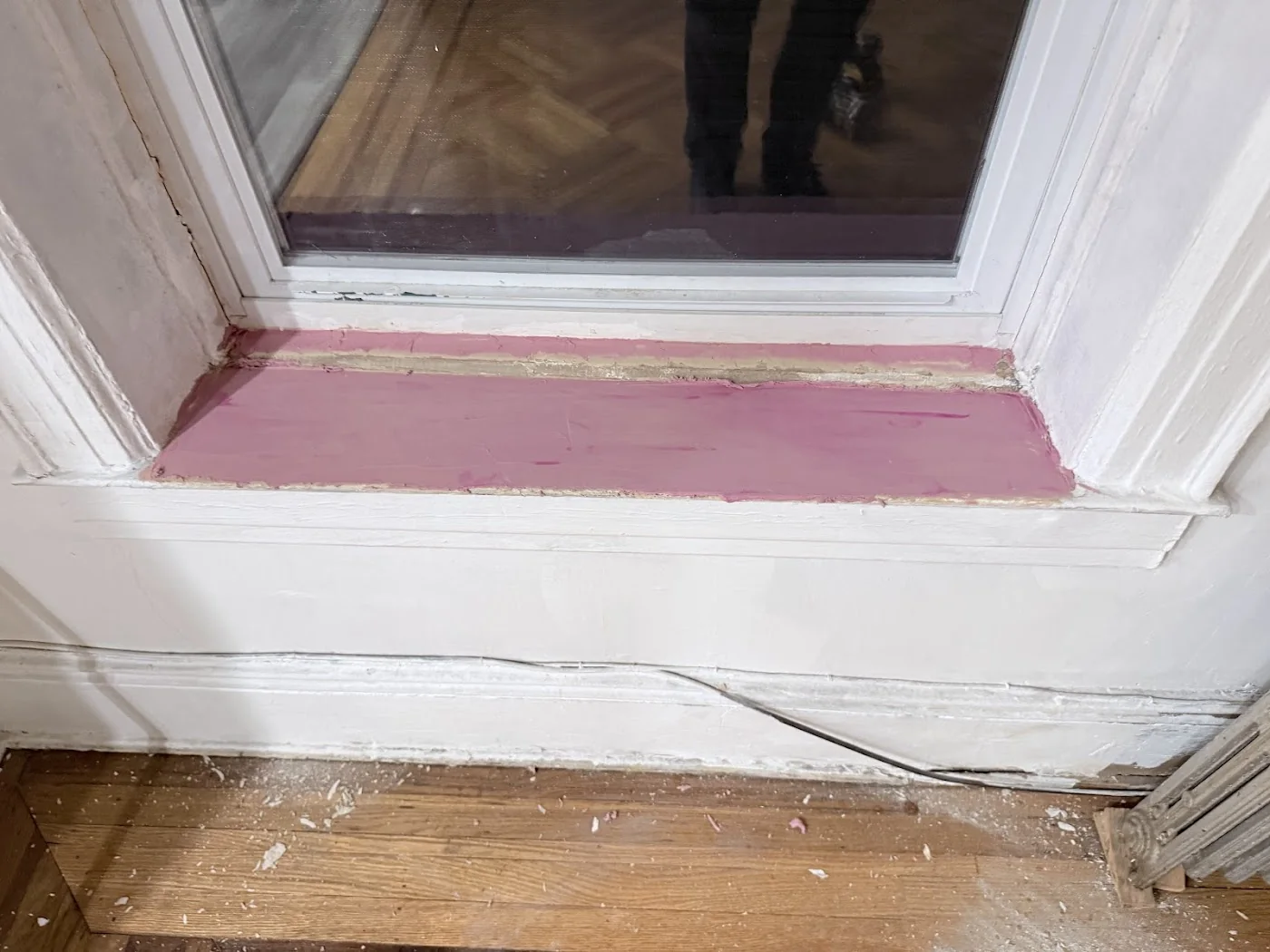 Window sill before repair with peeling paint and damaged surface