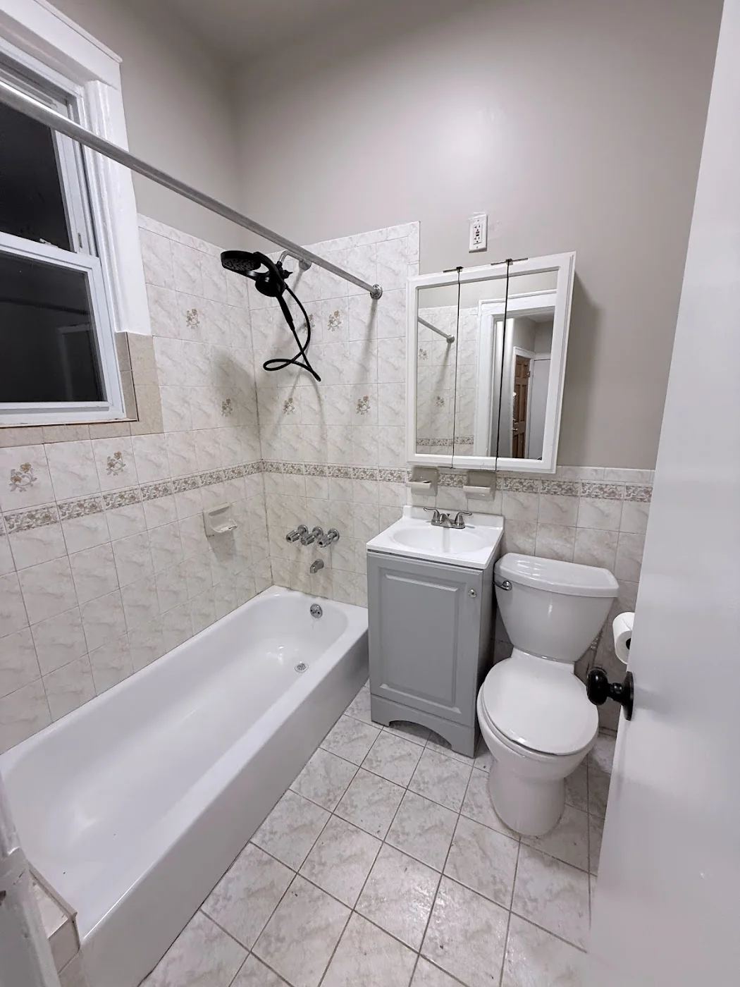 Finished bathroom after refresh with tub vanity toilet and new shower fixture