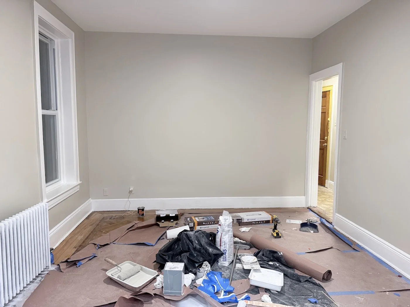 Painting and wall preparation in progress during apartment turnover