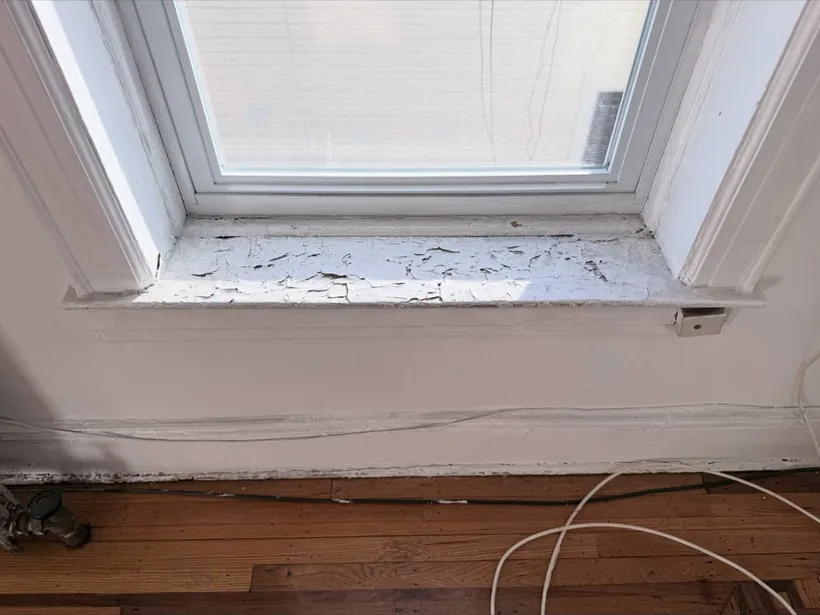 Damaged window sill before restoration