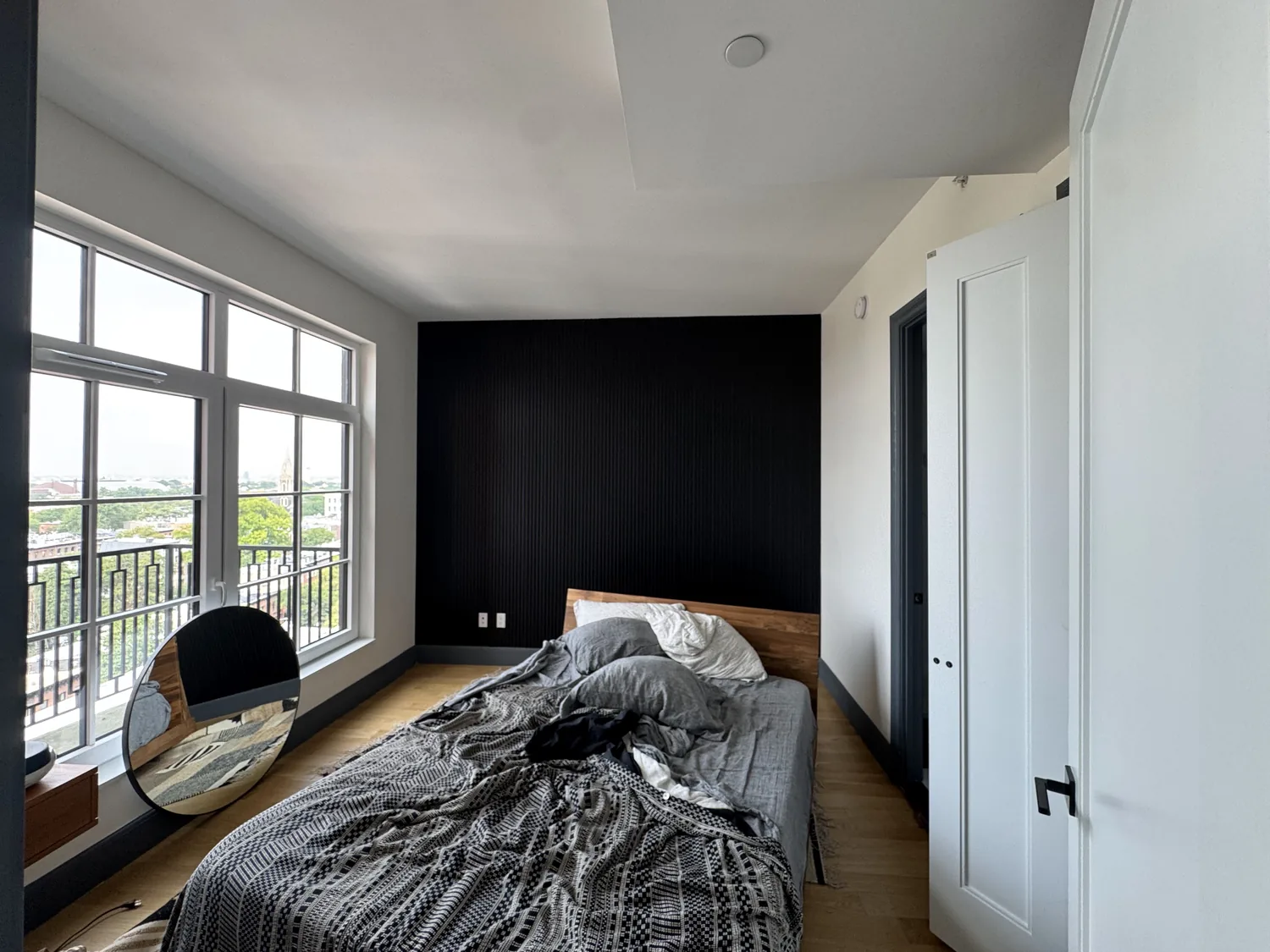 Finished black accent wall panels in a Brooklyn bedroom after installation