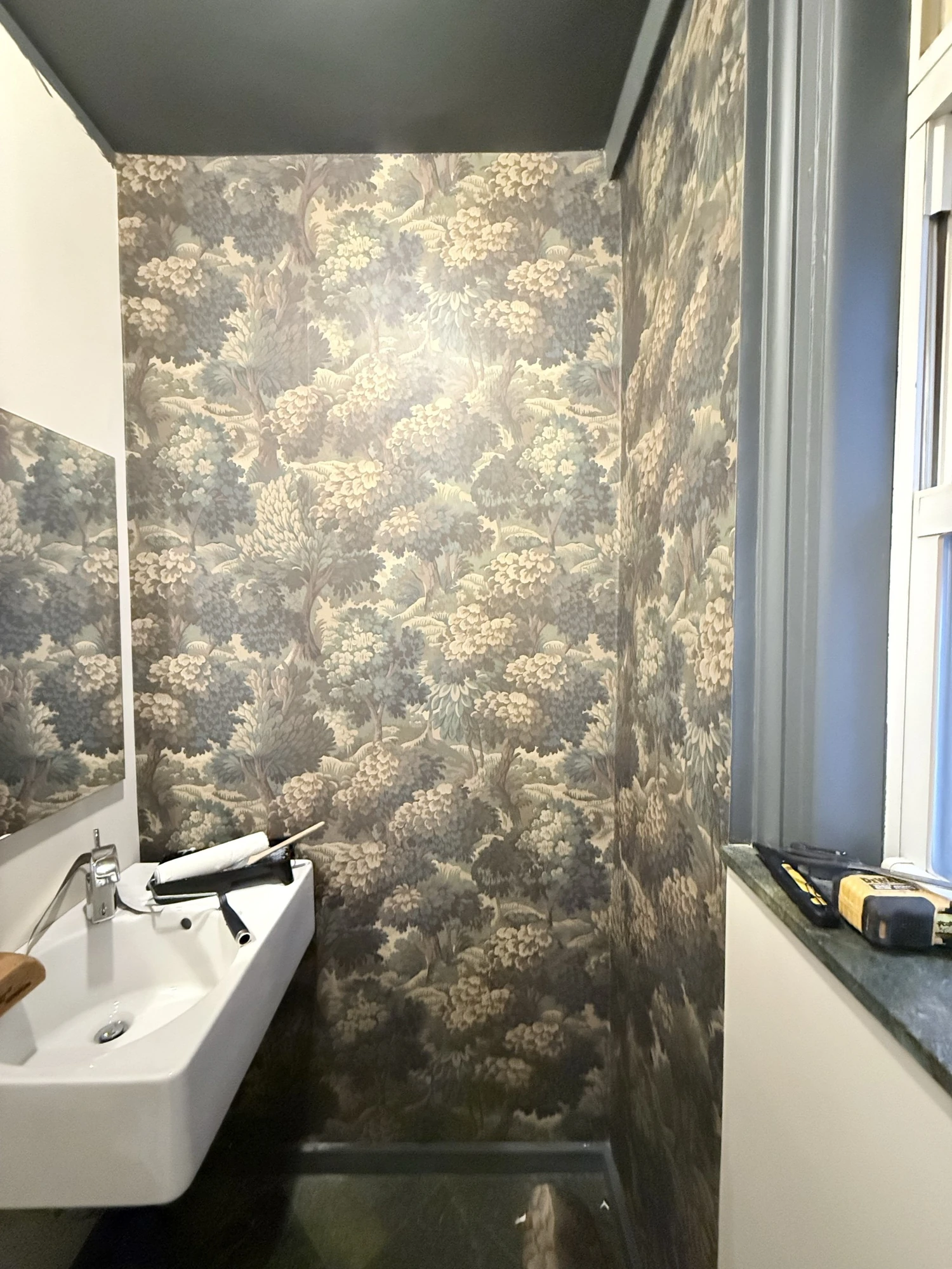 Finished botanical wallpaper beside the powder room window and sink, Upper West Side