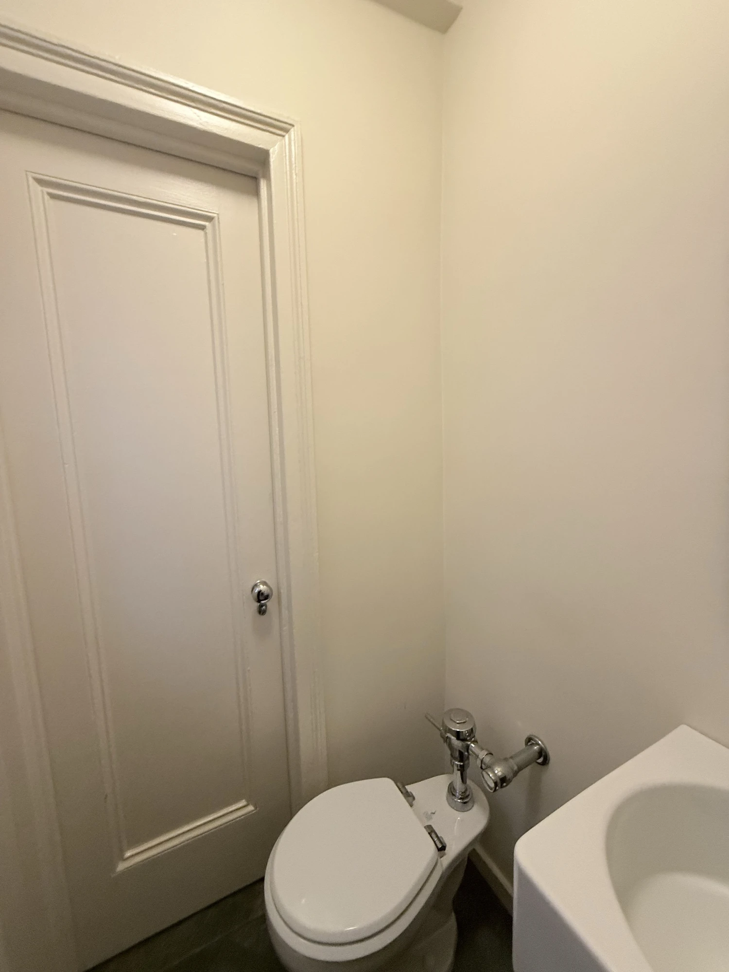 Plain white powder room door and wall before painting, Upper West Side Manhattan