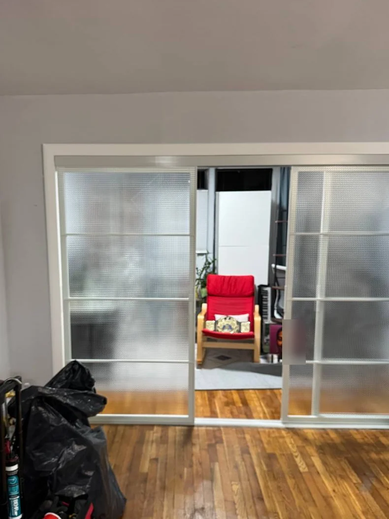 Sliding glass doors opened in the middle showing the home office behind, DUMBO Brooklyn apartment