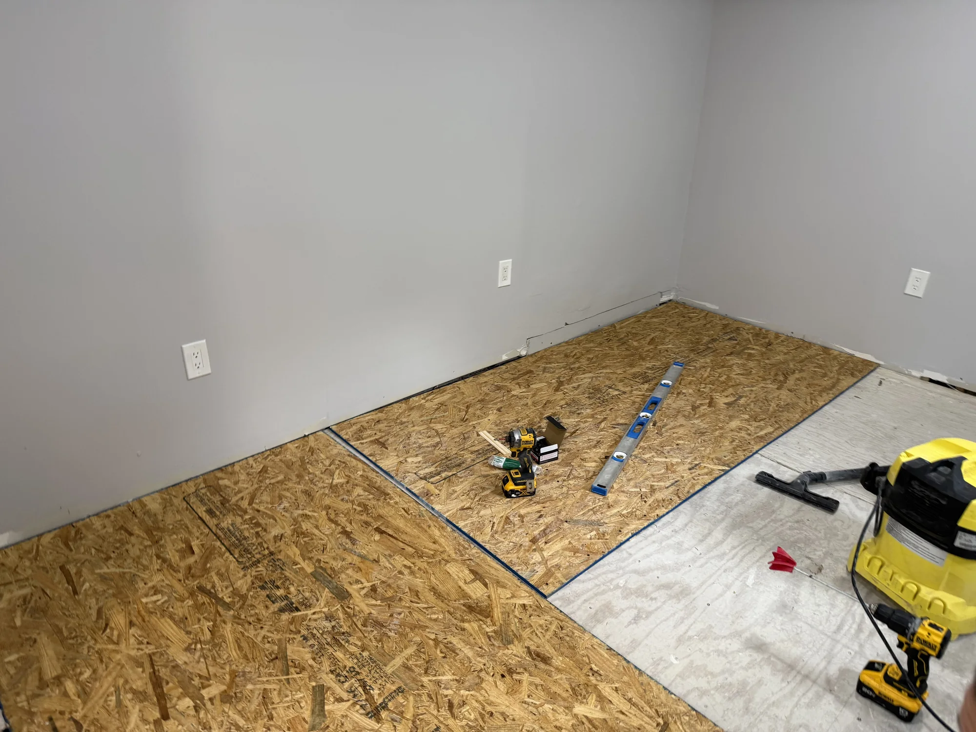 First OSB sheets laid over the old floor to level it