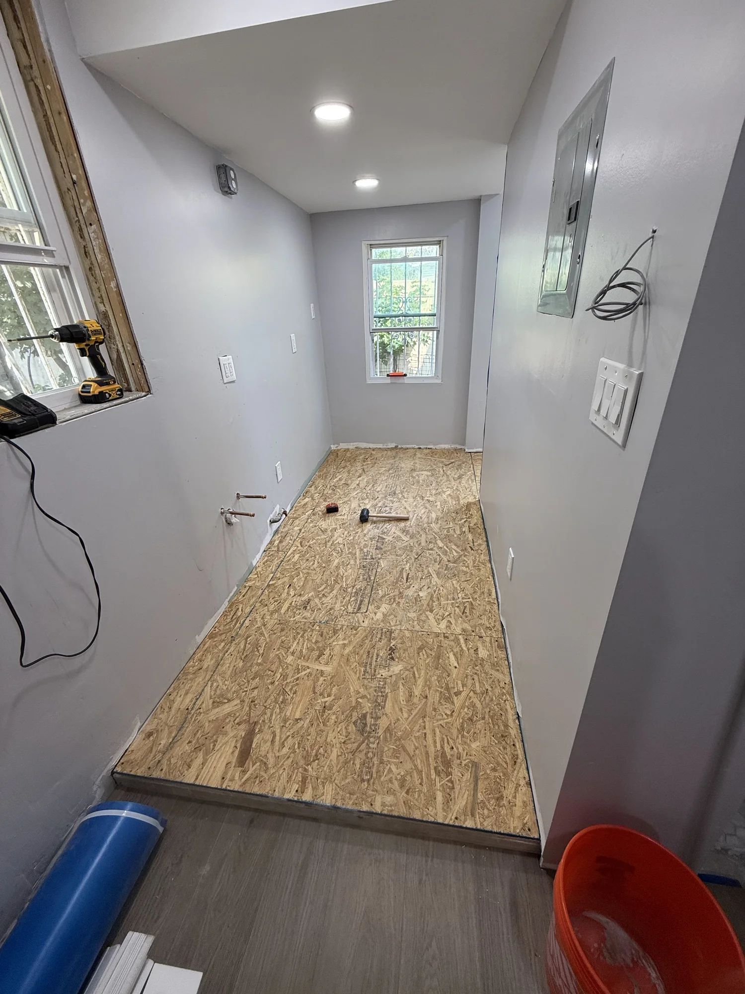 Hallway with OSB leveling sheets laid over the old floor, Hollis Queens home