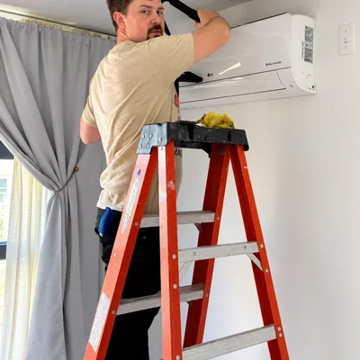 Our technician deep-cleaning an LG mini-split head in a NYC apartment