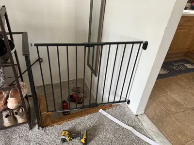 Black metal safety gate installed at staircase opening in NYC home by Repair ASAP LLC