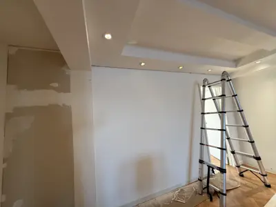 Drywall and ceiling repair in progress with ladder set up in NYC living space