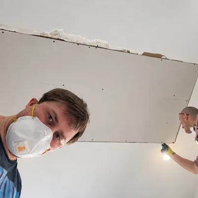 Our team fitting a new drywall ceiling patch after a leak